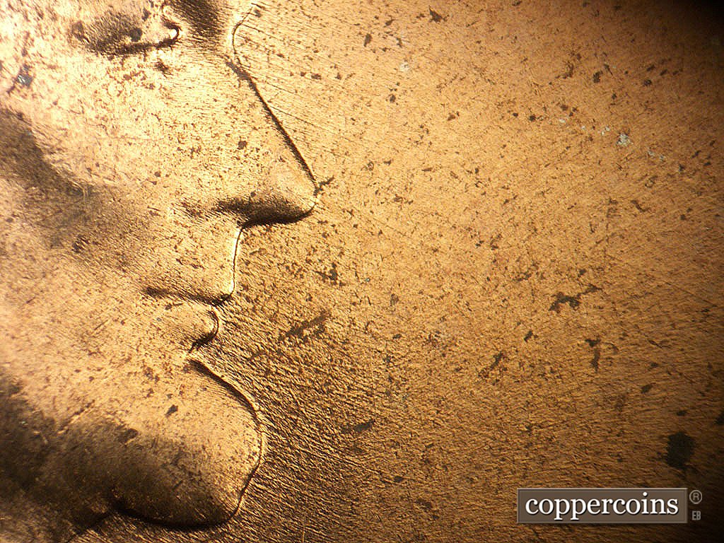 Die-stage B marker on 1964P•1DO•019 showing ESE die scratches from mouth.