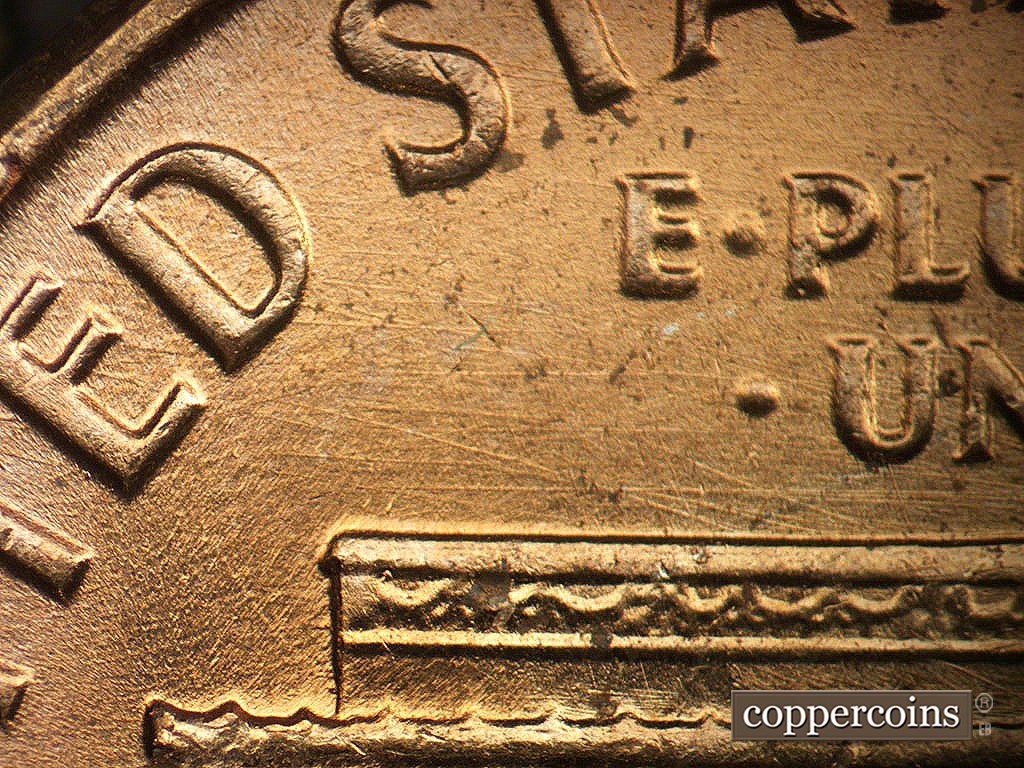 Die-stage B marker on 1964P•1DO•019 showing Multidierectional die scratches above left roof.