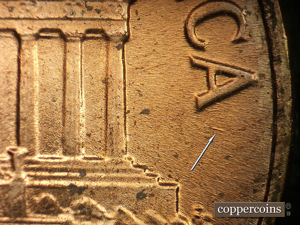 Die-stage B marker on 1964P•1DO•019 showing ESE die gouge under last A in AMERICA.