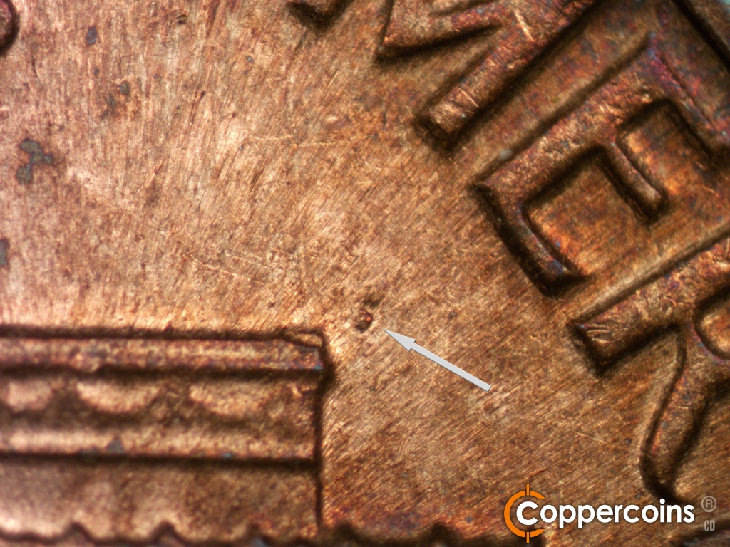 Die-stage C marker on 1974S•1MM•002 showing Die gouge near right roof.