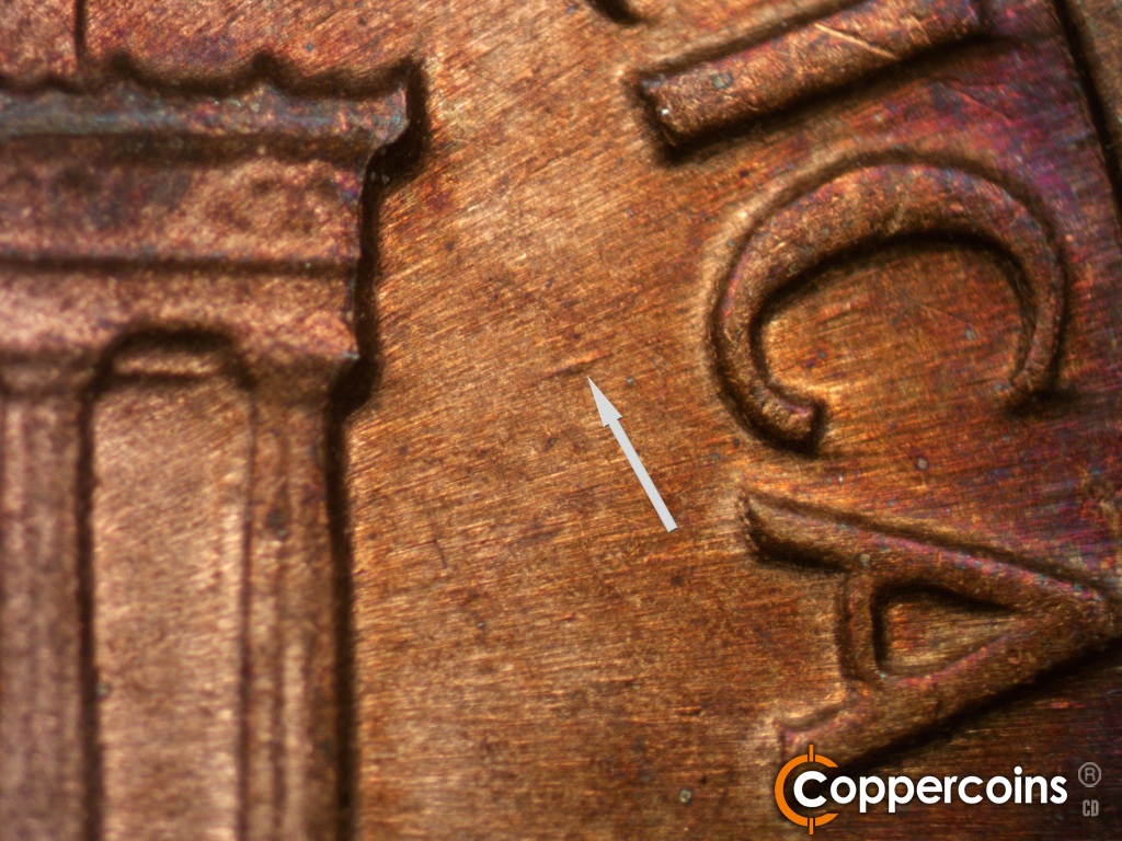 Die-stage C marker on 1974S•1MM•002 showing Die gouge between right cornice and C in AMERICA.