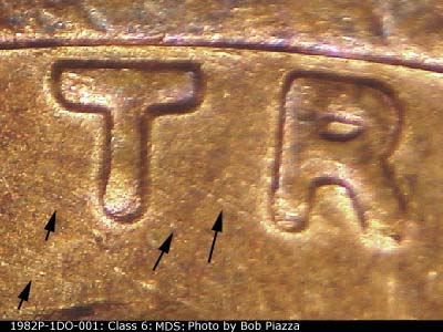Die-stage B marker on 1982P•1DO•001 (1982 Doubled Die Obverse).