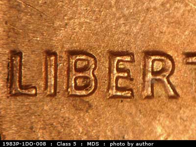 Die-stage B marker on 1983P•1DO•008 (1983 Doubled Die Obverse).