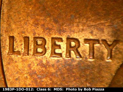 Die-stage B marker on 1983P•1DO•012 (1983 Doubled Die Obverse).