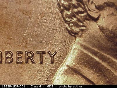 Die-stage B marker on 1983P•1DR•001 (1983 Doubled Die Reverse).