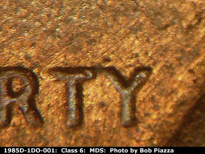 Die-stage B marker on 1985D•1DO•001 (1985 Doubled Die Obverse).