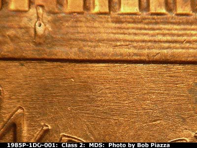 Die-stage B marker on 1985P•1DO•001 (1985 Doubled Die Obverse).