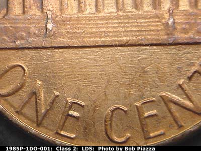 Die-stage C marker on 1985P•1DO•001 (1985 Doubled Die Obverse).