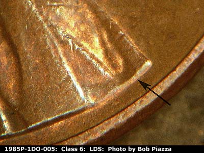 Die-stage C marker on 1985P•1DO•005 (1985 Doubled Die Obverse).