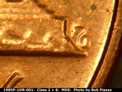 Die-stage B marker on 1985P•1DR•001 (1985 Doubled Die Reverse).