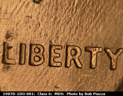 Die-stage B marker on 1987D•1DO•001 (1987 Doubled Die Obverse).