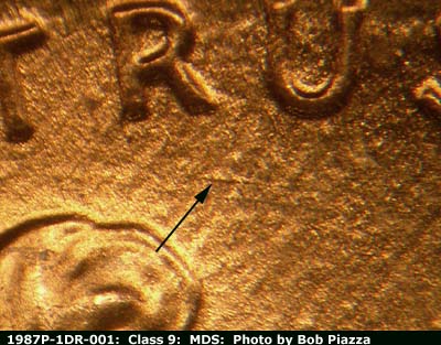 Die-stage B marker on 1987P•1DR•001 (1987 Doubled Die Reverse).