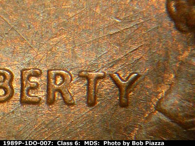 Die-stage B marker on 1989P•1DO•007 (1989 Doubled Die Obverse).