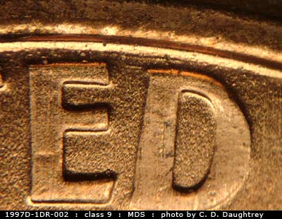 Die-stage B marker on 1997D•1DR•002 (1997 Doubled Die Reverse).