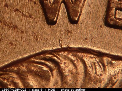 Die-stage B marker on 1997P•1DR•002 (1997 Doubled Die Reverse).