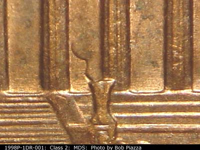 Die-stage B marker on 1998P•1DR•001 (1998 Doubled Die Reverse).