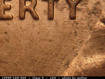 Die-stage C marker on 1999P•1DR•004 (1999 Doubled Die Reverse).