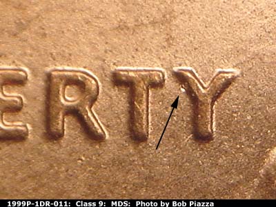 Die-stage B marker on 1999P•1DR•011 (1999 Doubled Die Reverse).