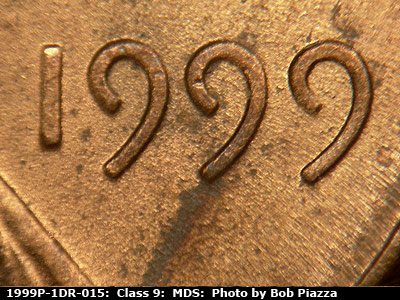 Die-stage B marker on 1999P•1DR•015 (1999 Doubled Die Reverse).