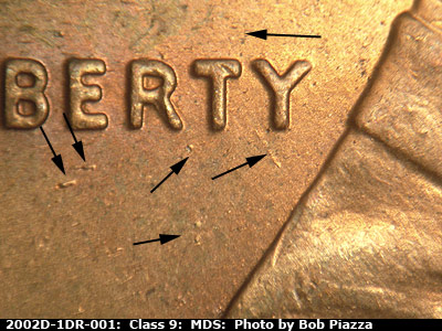 Die-stage B marker on 2002D•1DR•001 (2002 Doubled Die Reverse).