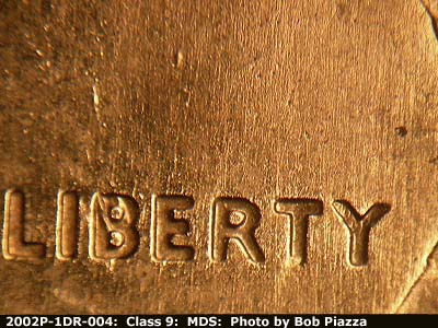Die-stage B marker on 2002P•1DR•004 (2002 Doubled Die Reverse).