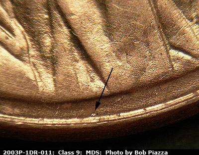 Die-stage B marker on 2003P•1DR•011 (2003 Doubled Die Reverse).