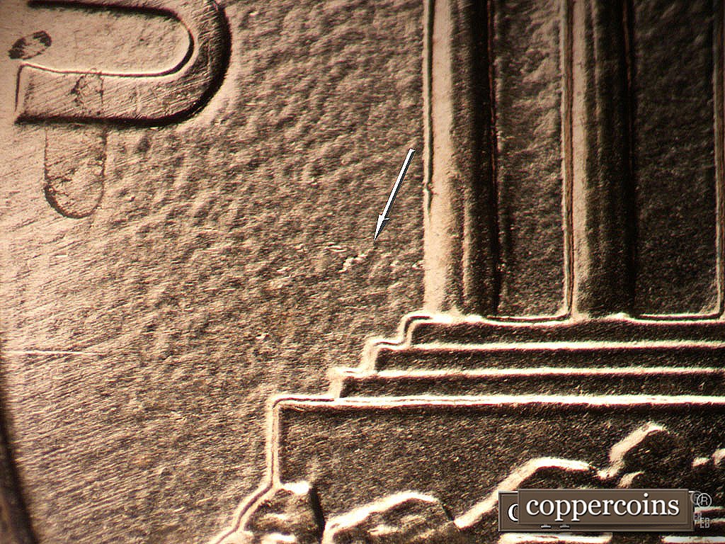 Die-stage B marker on 2003P•1DR•017 showing A linear series of die gouges runs E-W from the field near the bottom of the first memorial column.