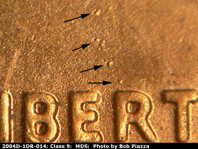 Die-stage B marker on 2004D•1DR•014 (2004 Doubled Die Reverse).