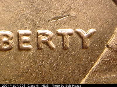 Die-stage B marker on 2004P•1DR•006 (2004 Doubled Die Reverse).
