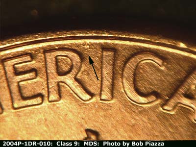 Die-stage B marker on 2004P•1DR•010 (2004 Doubled Die Reverse).