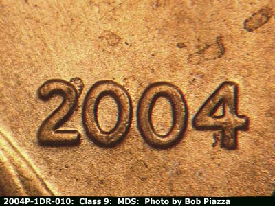Die-stage B marker on 2004P•1DR•010 (2004 Doubled Die Reverse).