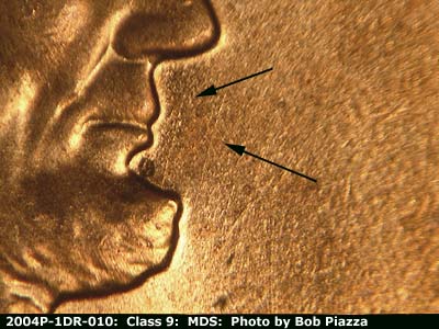 Die-stage B marker on 2004P•1DR•010 (2004 Doubled Die Reverse).