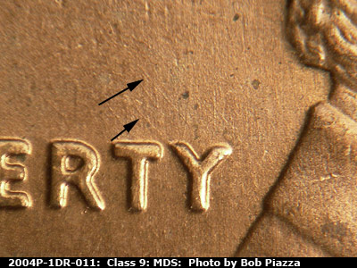 Die-stage B marker on 2004P•1DR•011 (2004 Doubled Die Reverse).