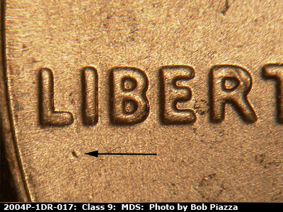 Die-stage B marker on 2004P•1DR•017 (2004 Doubled Die Reverse).