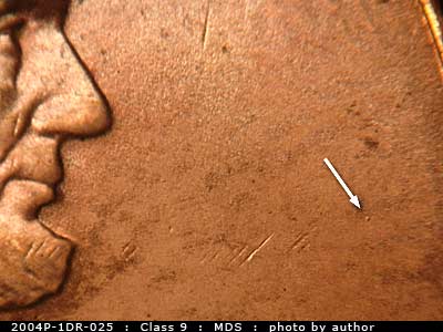 Die-stage B marker on 2004P•1DR•025 (2004 Doubled Die Reverse).