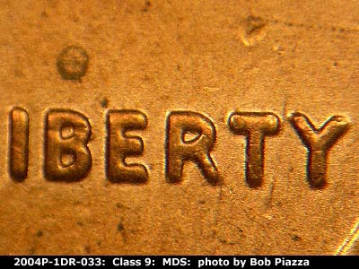 Die-stage B marker on 2004P•1DR•033 (2004 Doubled Die Reverse).