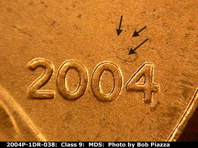 Die-stage B marker on 2004P•1DR•038 (2004 Doubled Die Reverse).