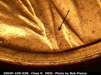 Die-stage B marker on 2004P•1DR•038 (2004 Doubled Die Reverse).