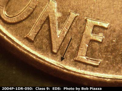 Die-stage A marker on 2004P•1DR•050 (2004 Doubled Die Reverse).