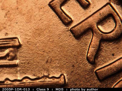 Die-stage B marker on 2005P•1DR•013 (2005 Doubled Die Reverse).