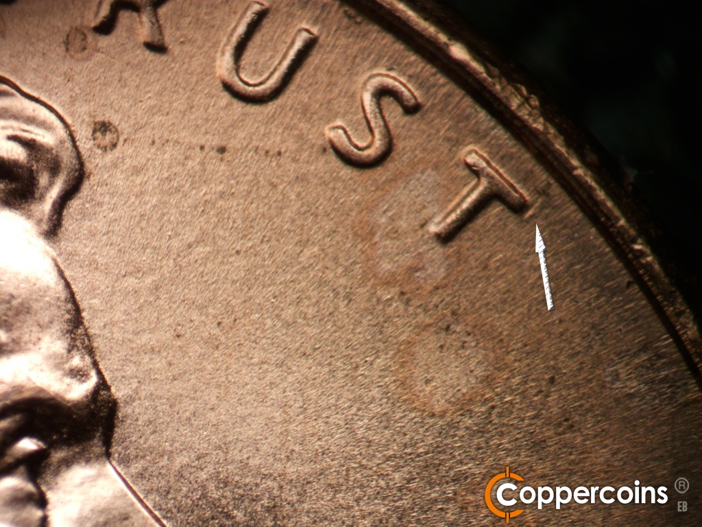 Die-stage B marker on 2006P•1DR•041 showing Small die gouge near the top of the last T in TRUST.