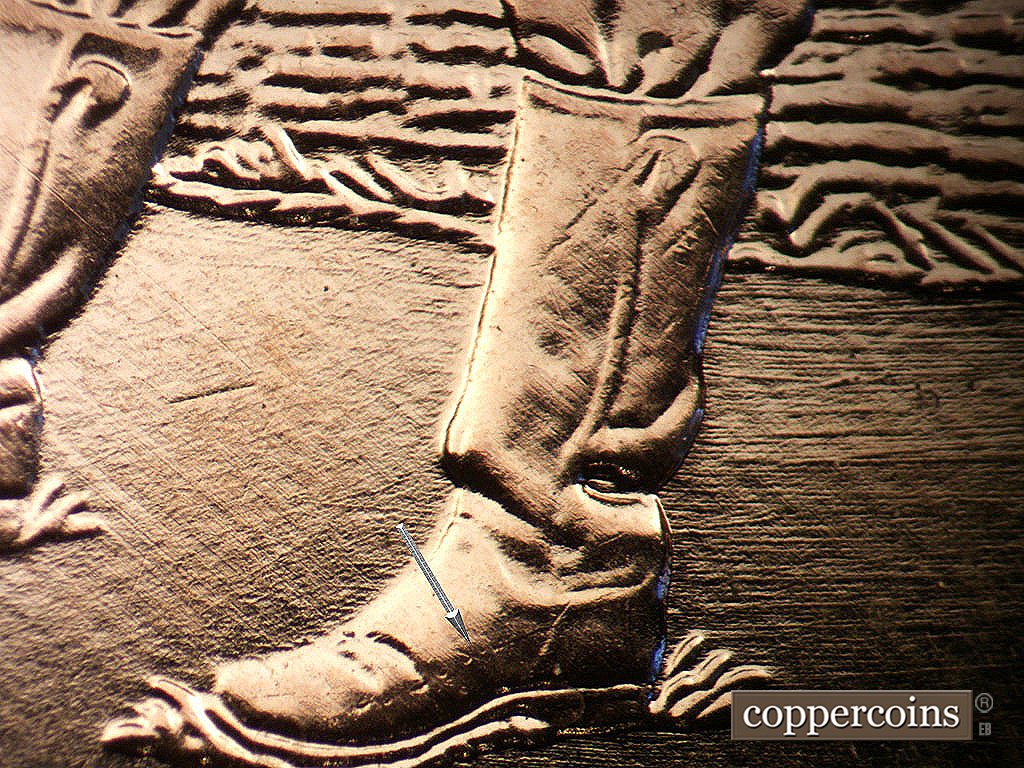 Die-stage A marker on 2009P•1DO•011 showing Die crack on boot.