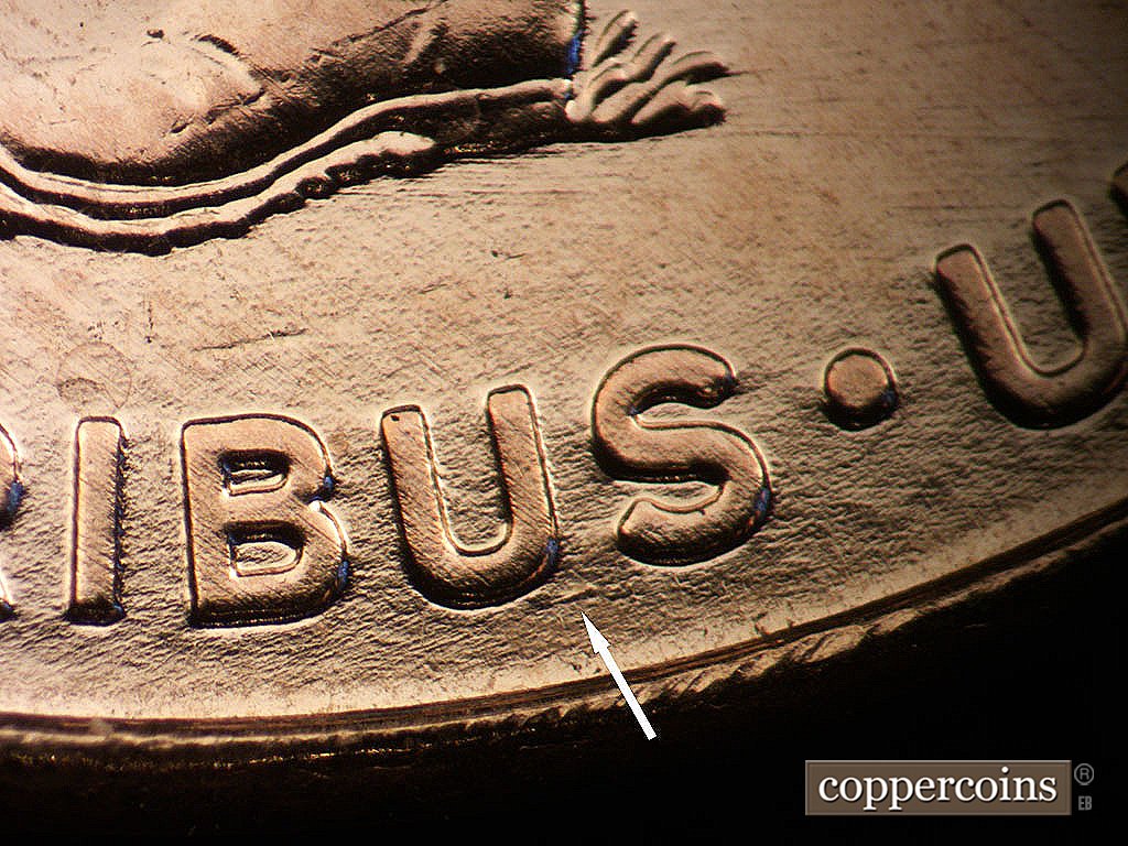 Die-stage A marker on 2009P•1DO•011 showing Small die gouge between US in PLURIBUS.
