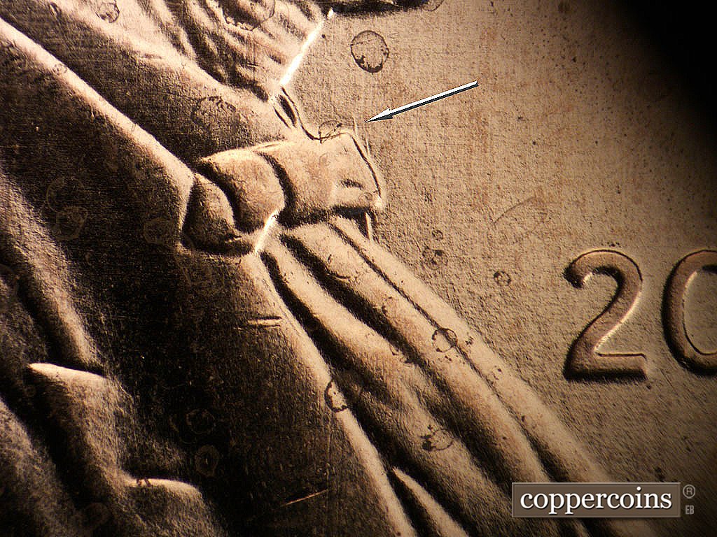 Die-stage A marker on 2009P•1DR•008 showing N/S die gouges form bowtie.