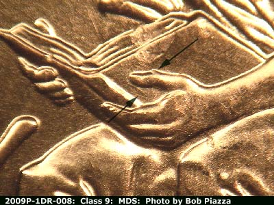 2009 Lincoln cent obverse, CopperCoins die 2009P•1DR•008 — A small portion of an additional thumb can be seen above the primary thumb. A light line under the thumb appears to b….