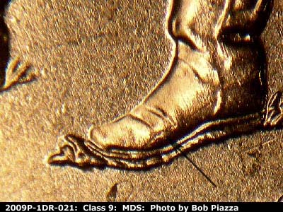 Die-stage B marker on 2009P•1DR•021 (2009 Doubled Die Reverse).