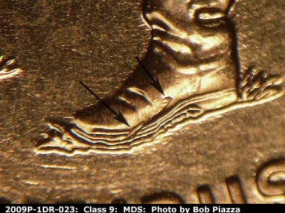 Die-stage B marker on 2009P•1DR•023 (2009 Doubled Die Reverse).