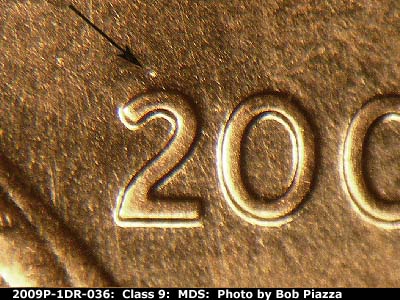 Die-stage B marker on 2009P•1DR•036 (2009 Doubled Die Reverse).