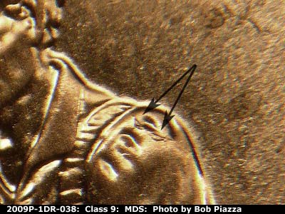 Die-stage B marker on 2009P•1DR•038 (2009 Doubled Die Reverse).