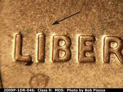 Die-stage B marker on 2009P•1DR•046 (2009 Doubled Die Reverse).